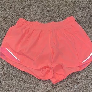 Neon orange lululemon tall hotty hot shorts 4”